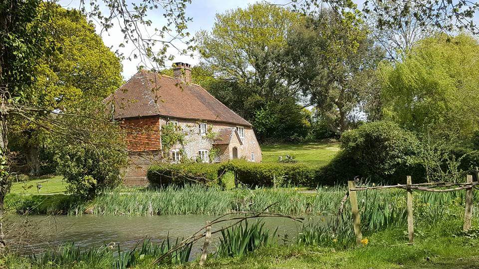 Historic Sussex farmhouse with clean windows and a traditional roofline