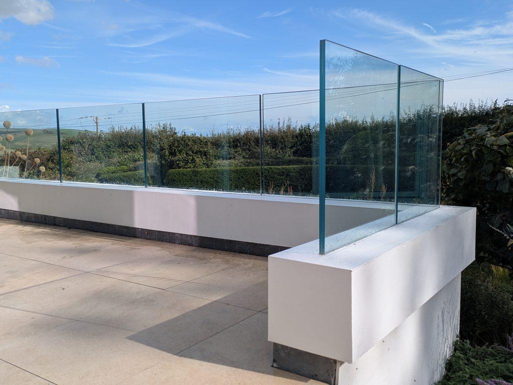 Balcony glass cleaned with a view of blue skies and gardens near Stonegate