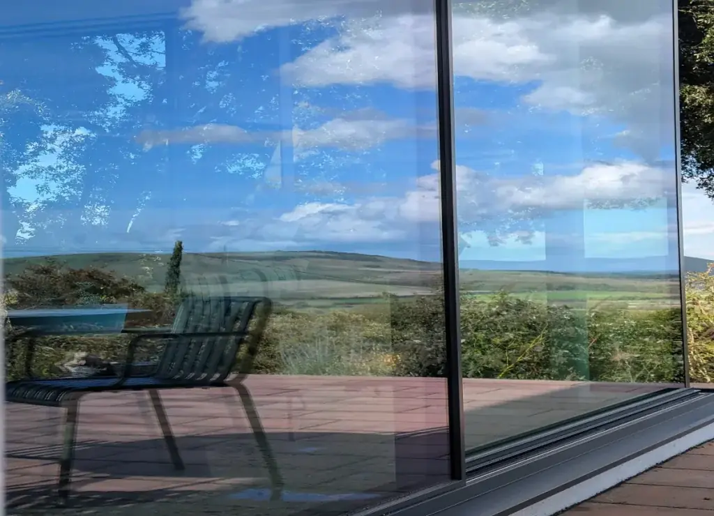 Clean modern glazing reflecting the countryside